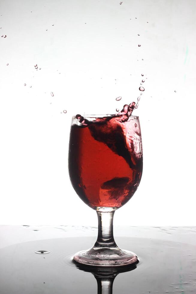 splashing cocktail into a wine glass photo