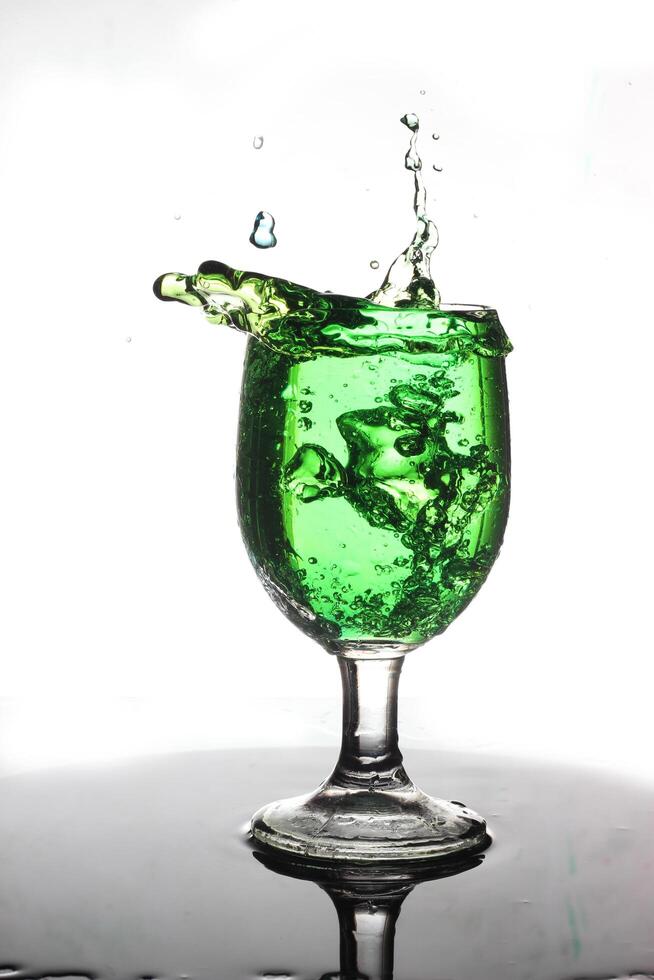 splashing cocktail into a wine glass photo