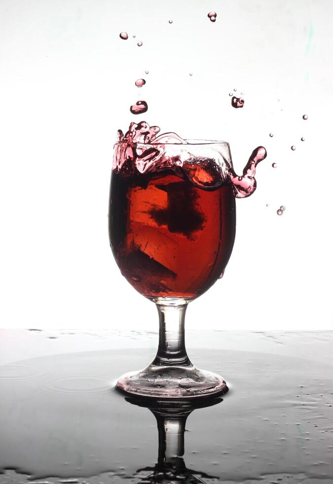 splashing cocktail into a wine glass photo