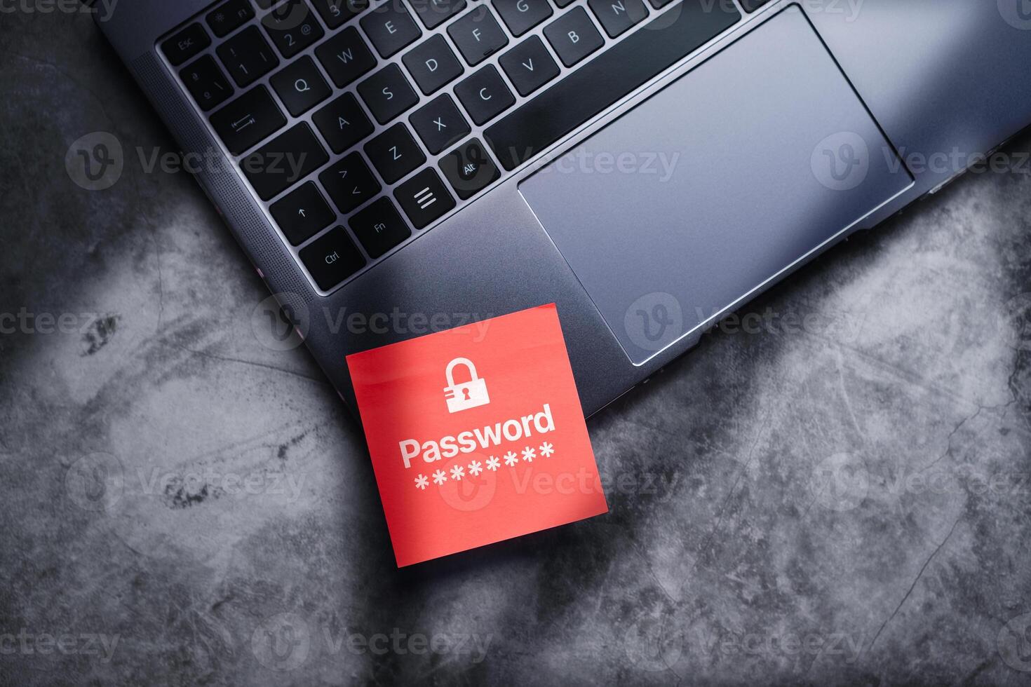 Red post it on laptop with password written on it to protect information on digital devices. Cybersecurity and privacy protect data. Pin code. Cyber hacker threat. photo