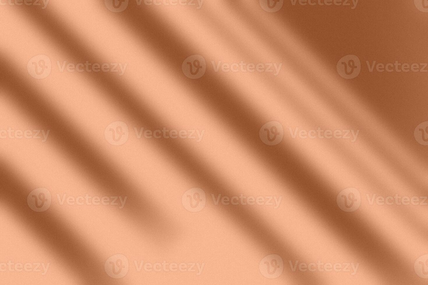 Contrast shadows on concrete wall in Peach Fuzz color of the year. Shadow overlay effect. Scene of natural lighting. Blank background for design. Background for ideas. photo