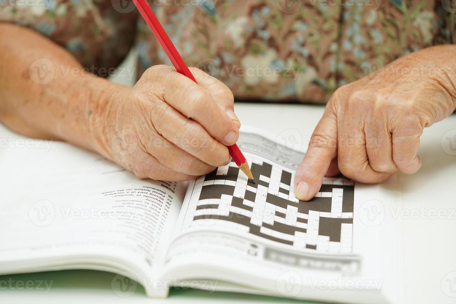 elderly woman playing sudoku puzzle game for treatment dementia prevention and Alzheimer disease. photo