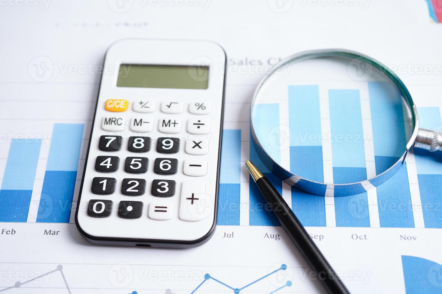 Calculator on chart graph paper. Finance, account, statistic, investment data economy, stock exchange business. photo