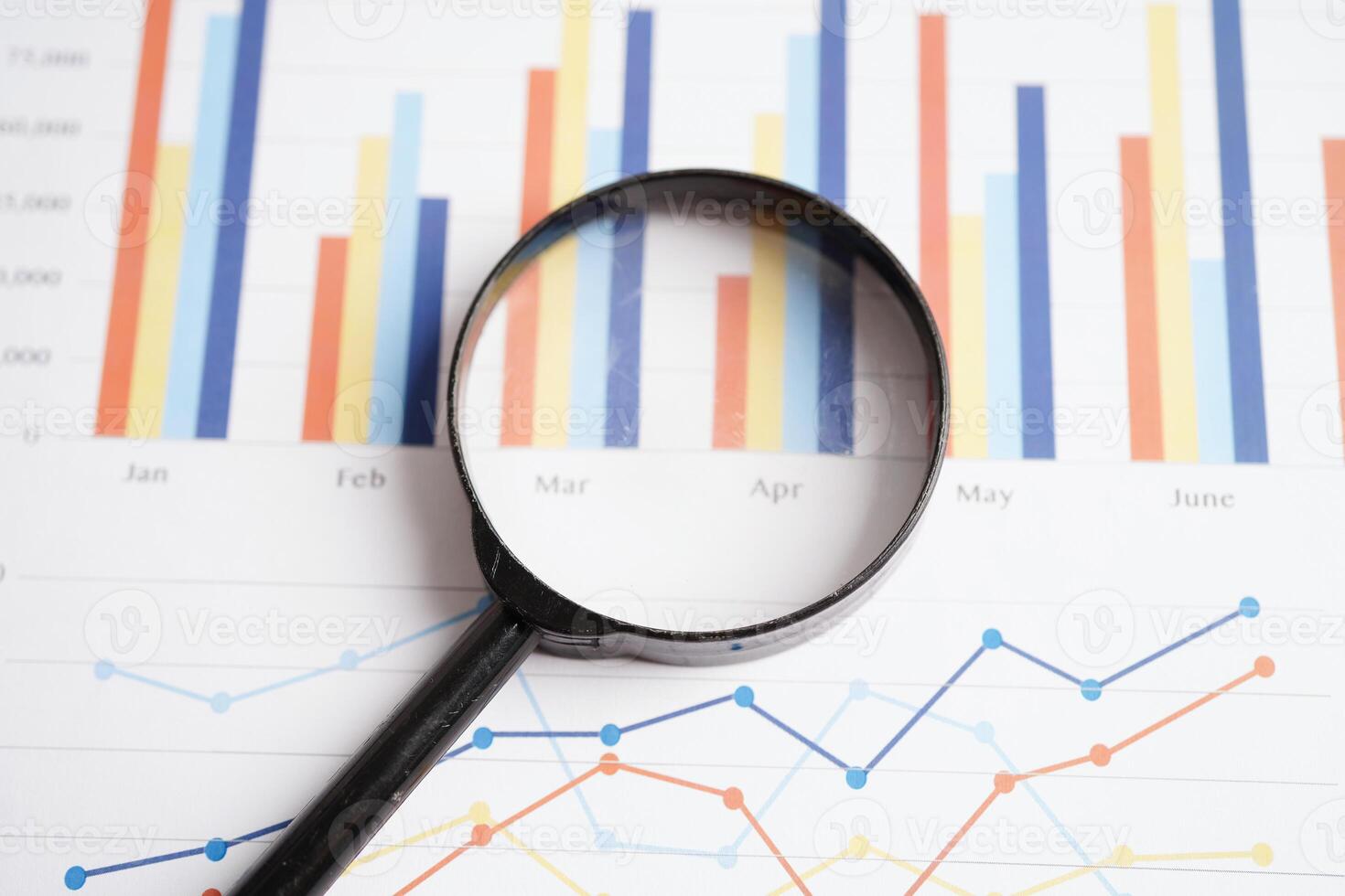 Magnifying glass on charts graphs paper. Financial development, Banking Account, Statistics, Investment Analytic research data economy. photo
