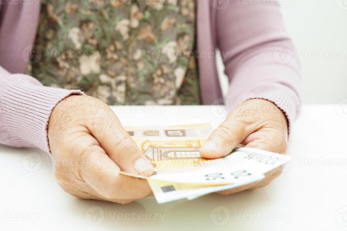 Retired elderly woman counting coins money and worry about monthly expenses and treatment fee payment. photo