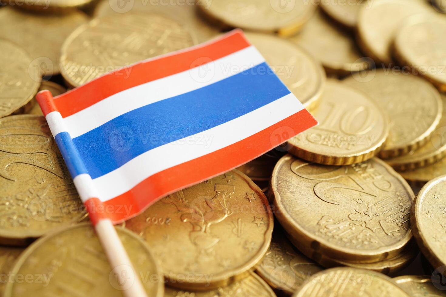 Thailand flag on coins background, finance and accounting, banking concept. photo