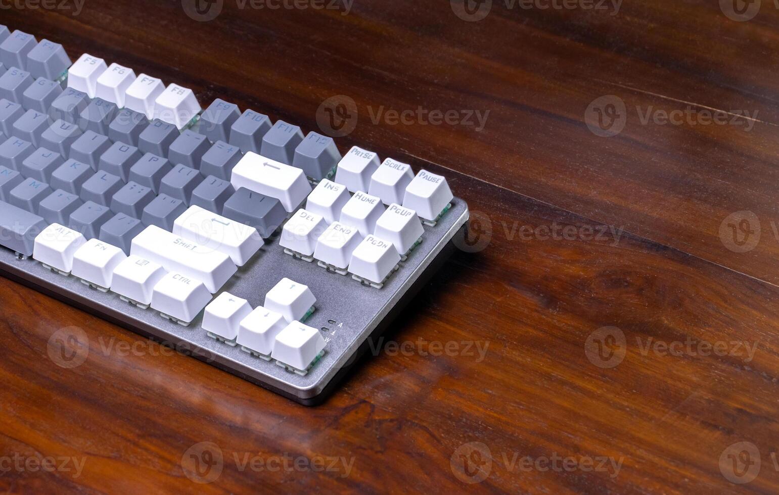 A modern mechanical keyboard on a wooden table. After some edits. photo