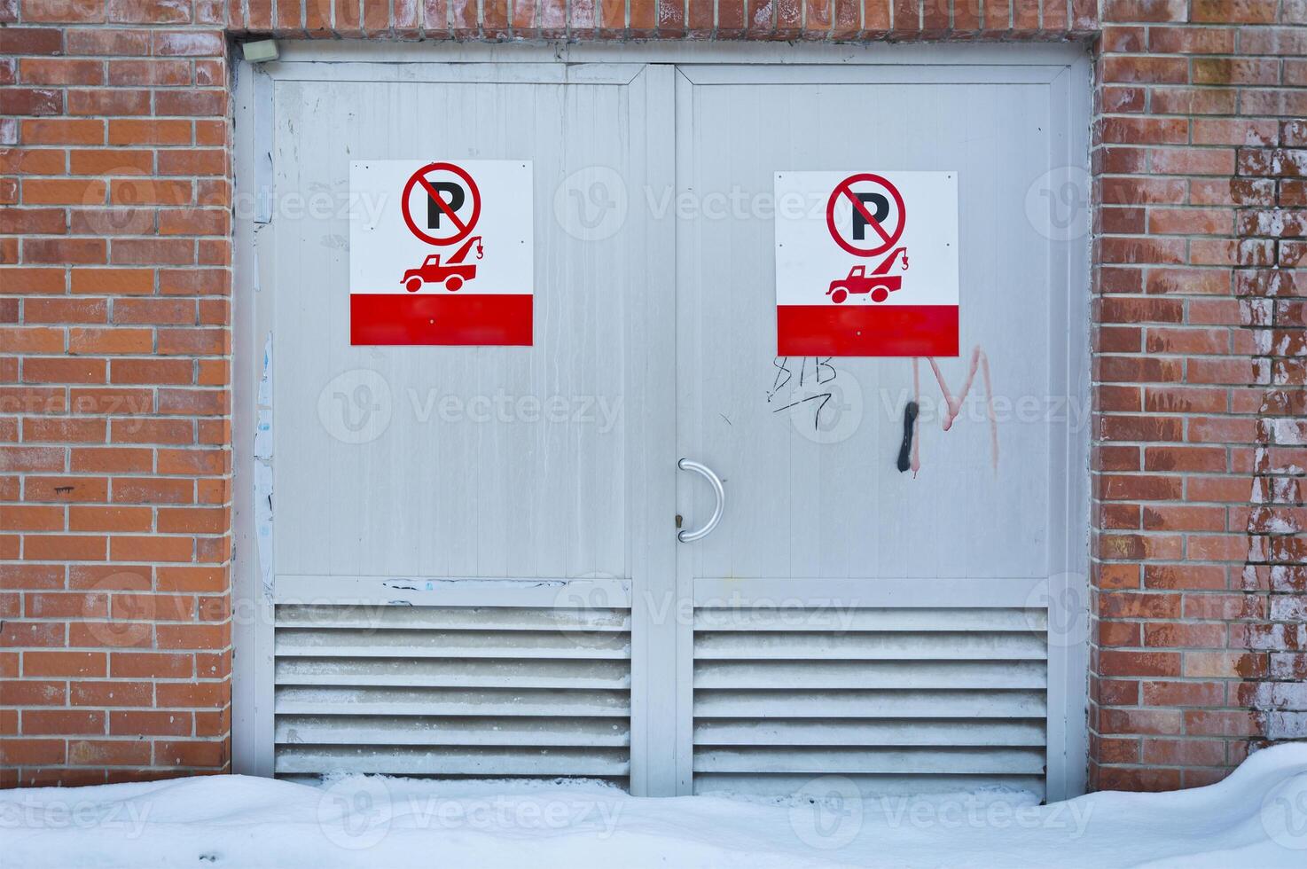 Snow covered alley red metal door entrance photo