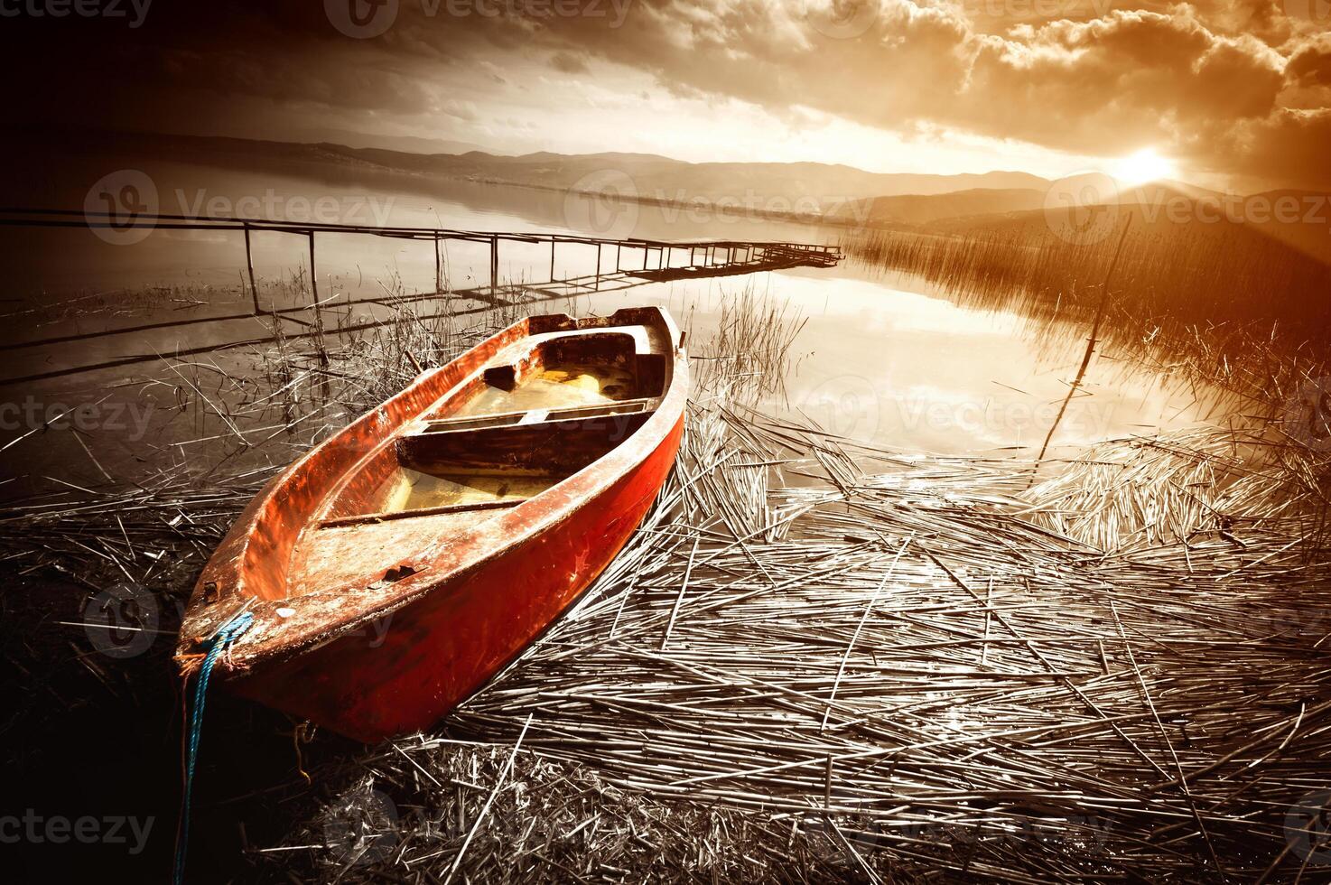 Old Boat on Lake at Sunset photo