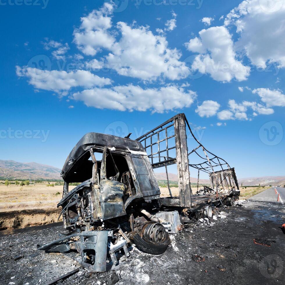 Burned truck waiting on road photo