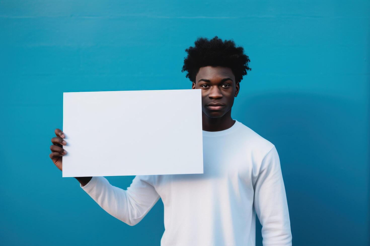 AI generated a young black man holding an empty white board greeting card photo