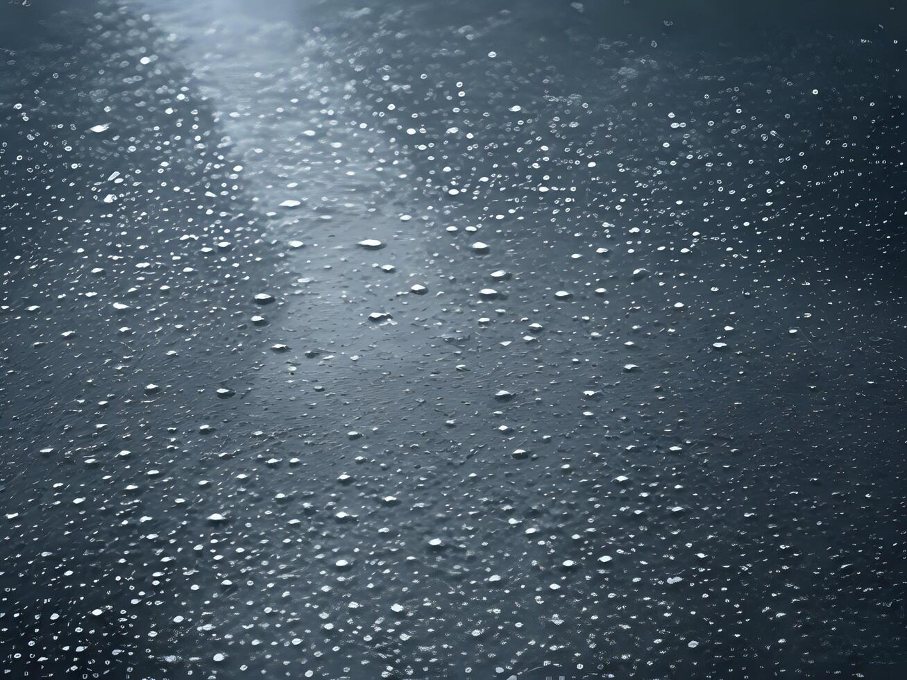 ai generado gotas de lluvia en un negro superficie con un ligero brillante mediante foto