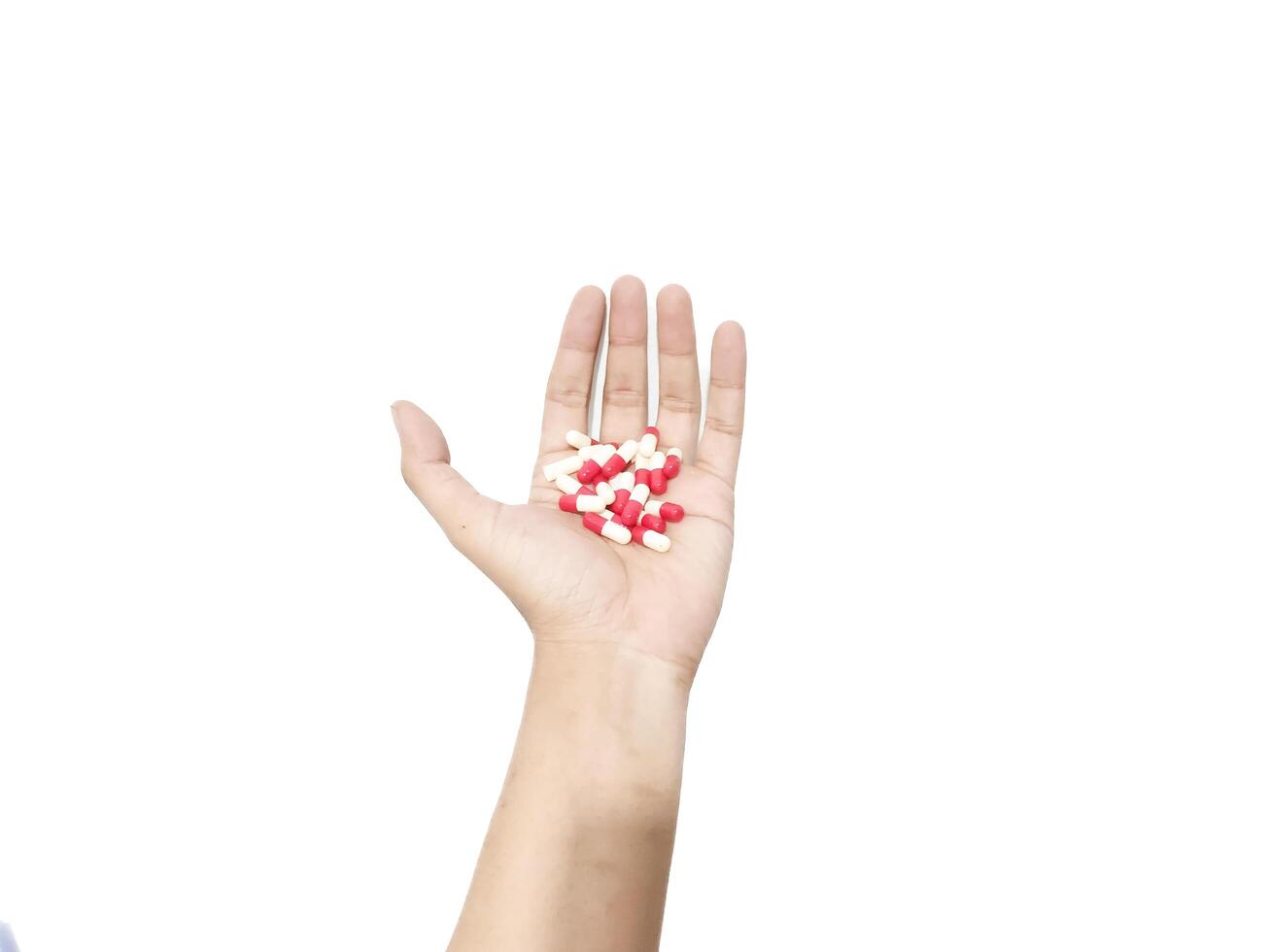capsule pills placed in the palm of the hand isolated on a white background photo