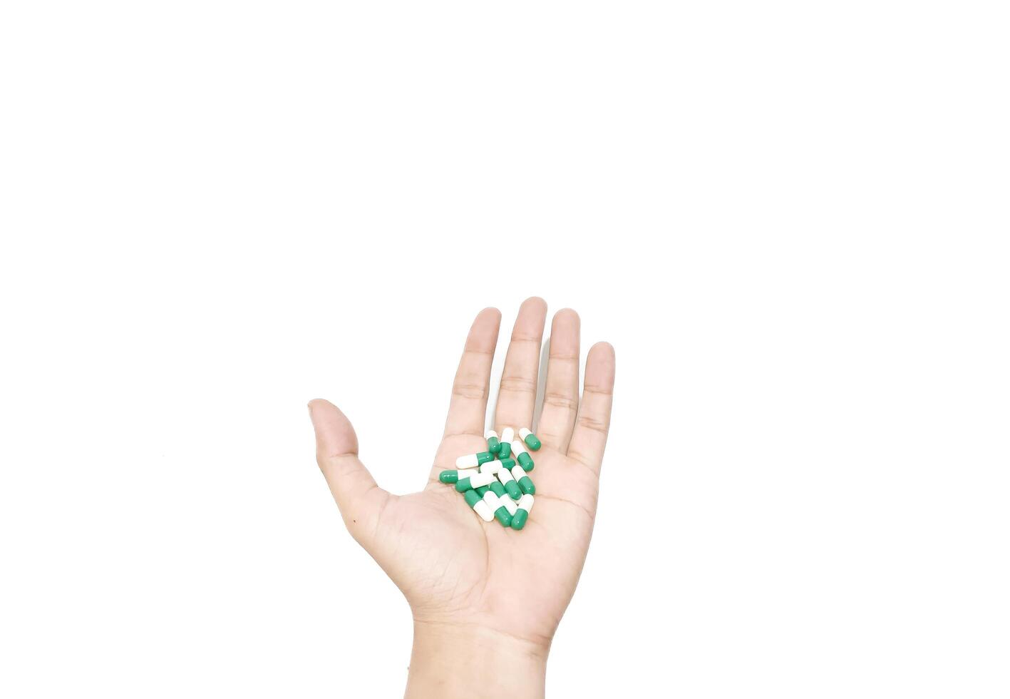 capsule pills placed in the palm of the hand isolated on a white background photo