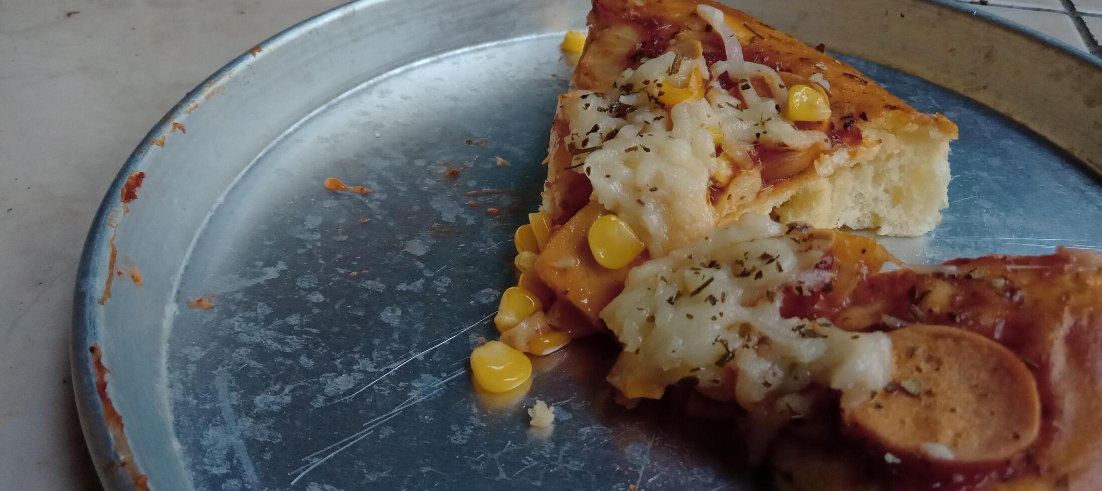 Corn pizza slice with cheese and sausage photo