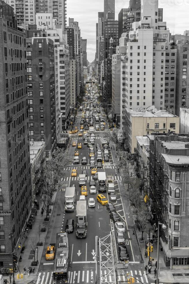Iconic view of 1st avenue, New York city in black and white with yellow cabs shot from the Roosevelt cable cart photo