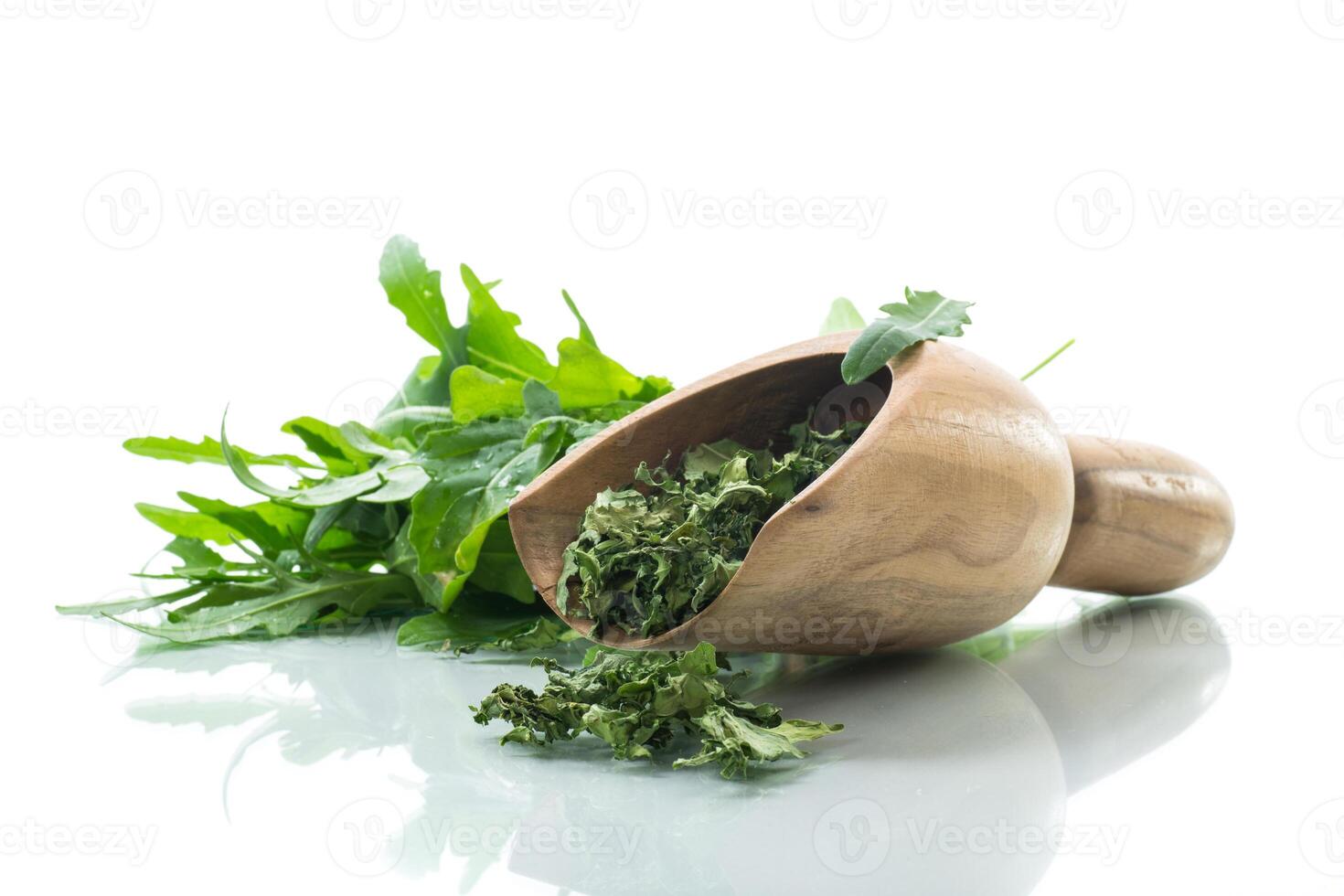 dried green organic arugula, seasoning, on white background. photo