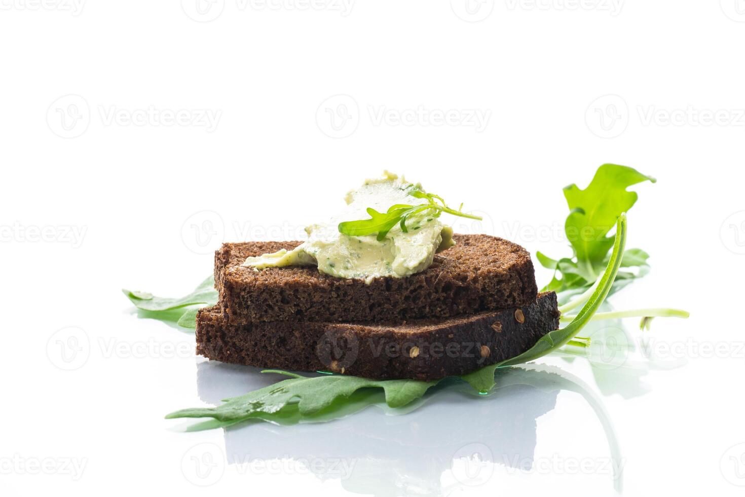 bread cheese spread with garlic and arugula on dark bread photo