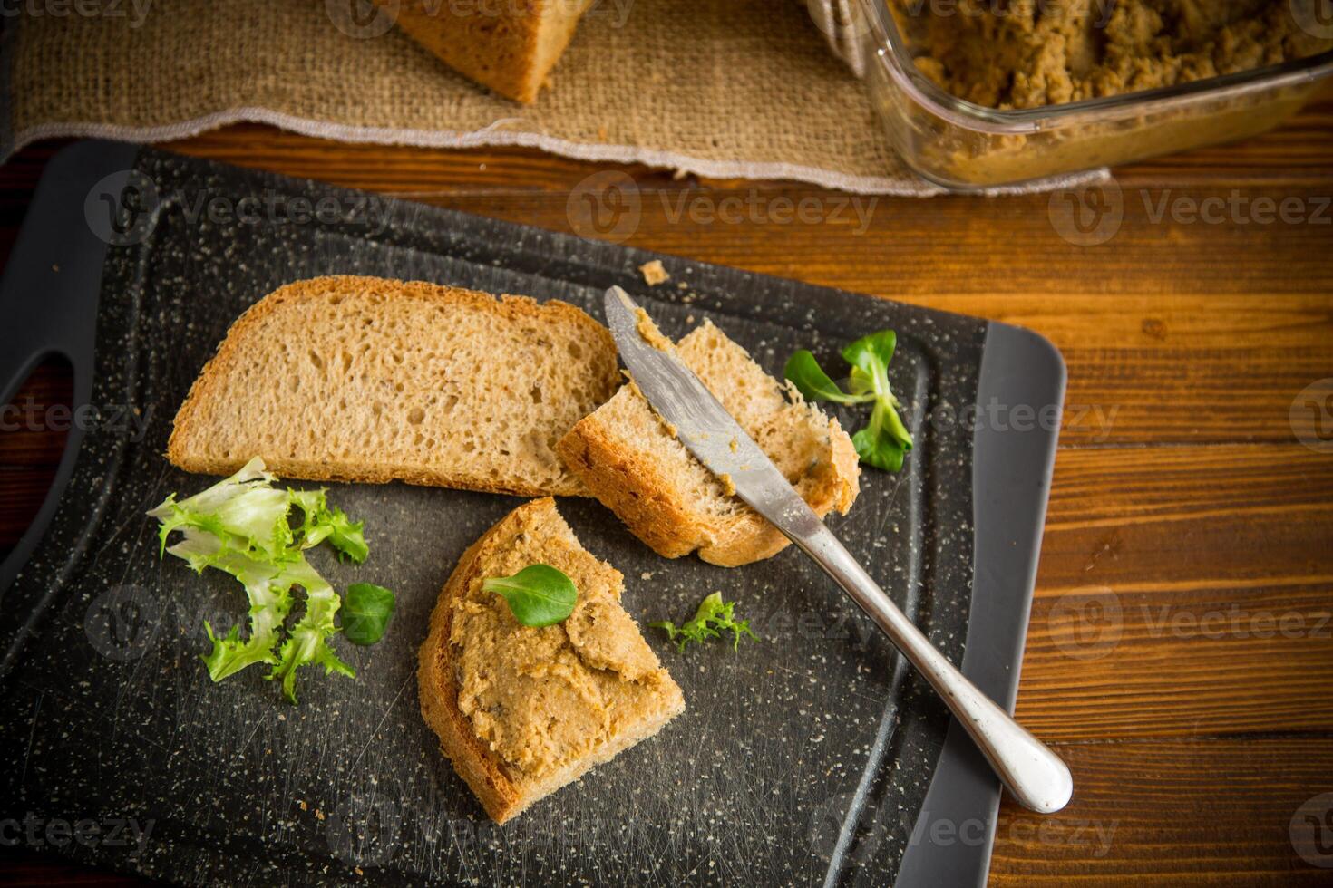 homemade meat pate with bread on a wooden table photo