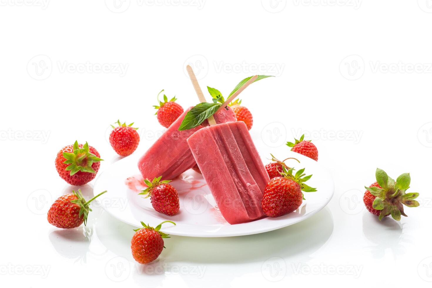 homemade strawberry ice cream on a stick made from fresh strawberries in a plate photo