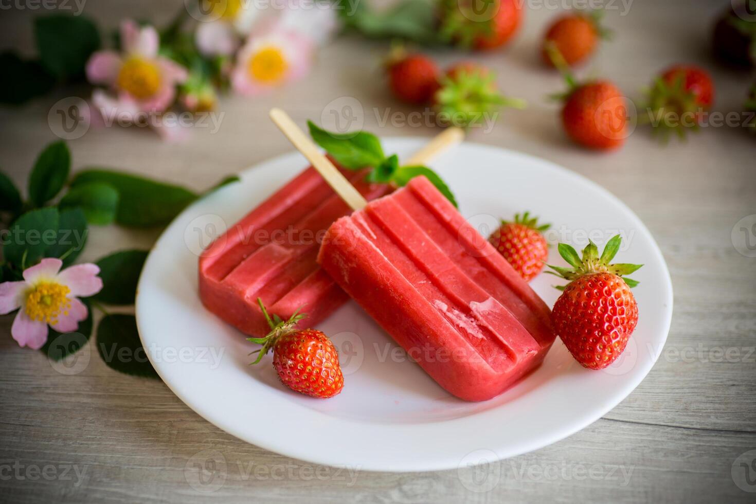 homemade strawberry ice cream on a stick made from fresh strawberries in a plate photo