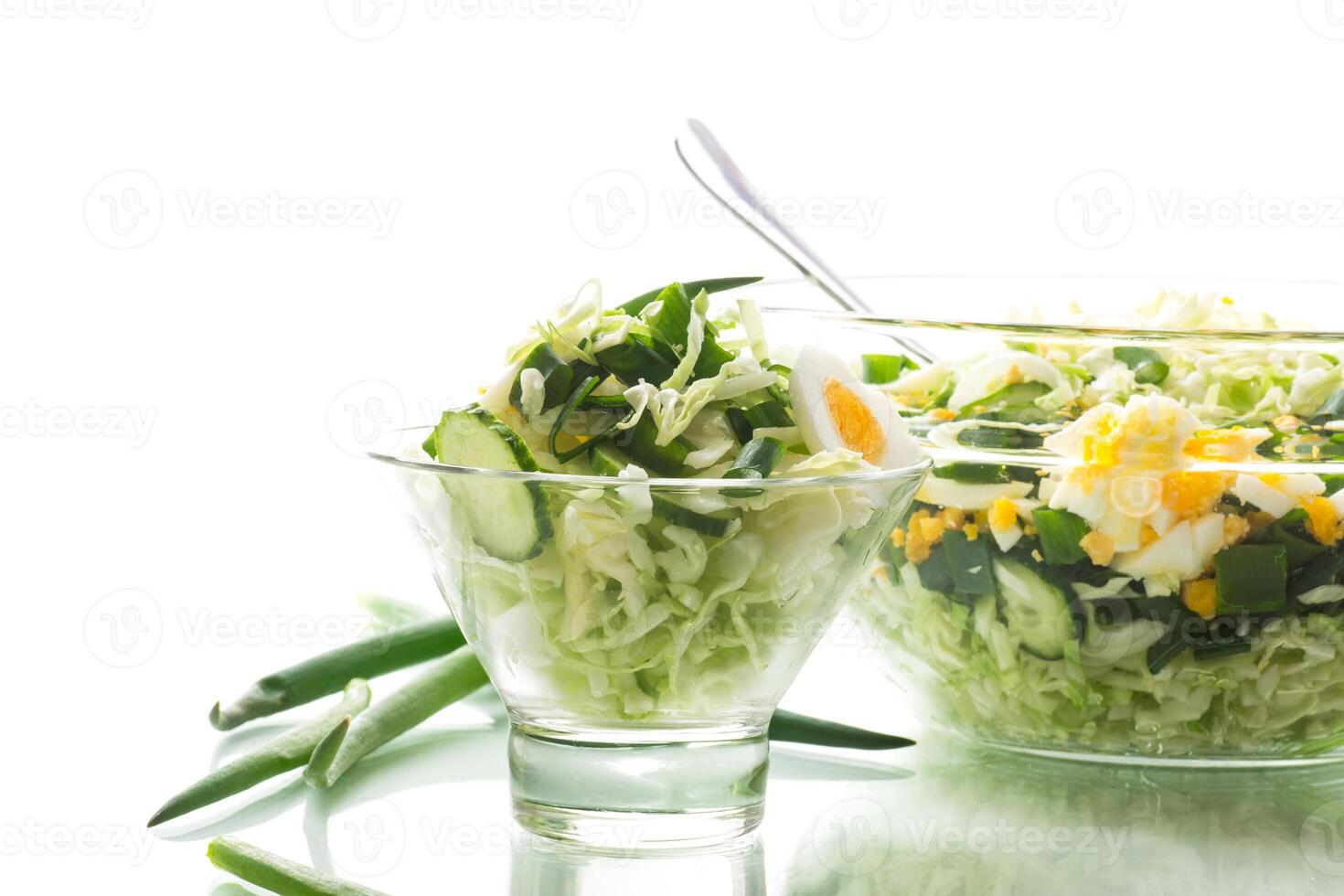 spring salad with early cabbage, cucumbers, eggs and green onions photo