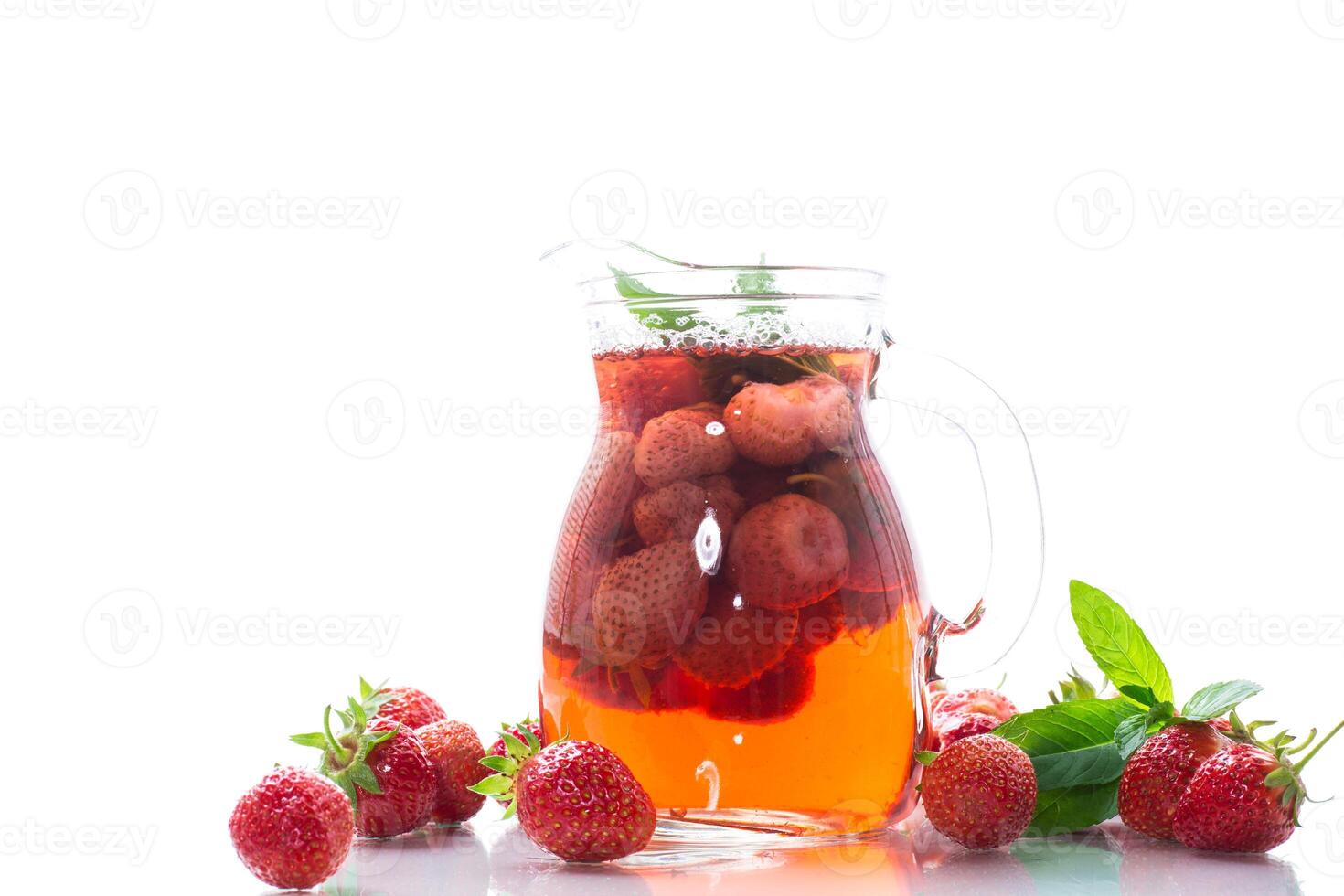 Sweet refreshing berry compote of ripe strawberries in a decanter photo