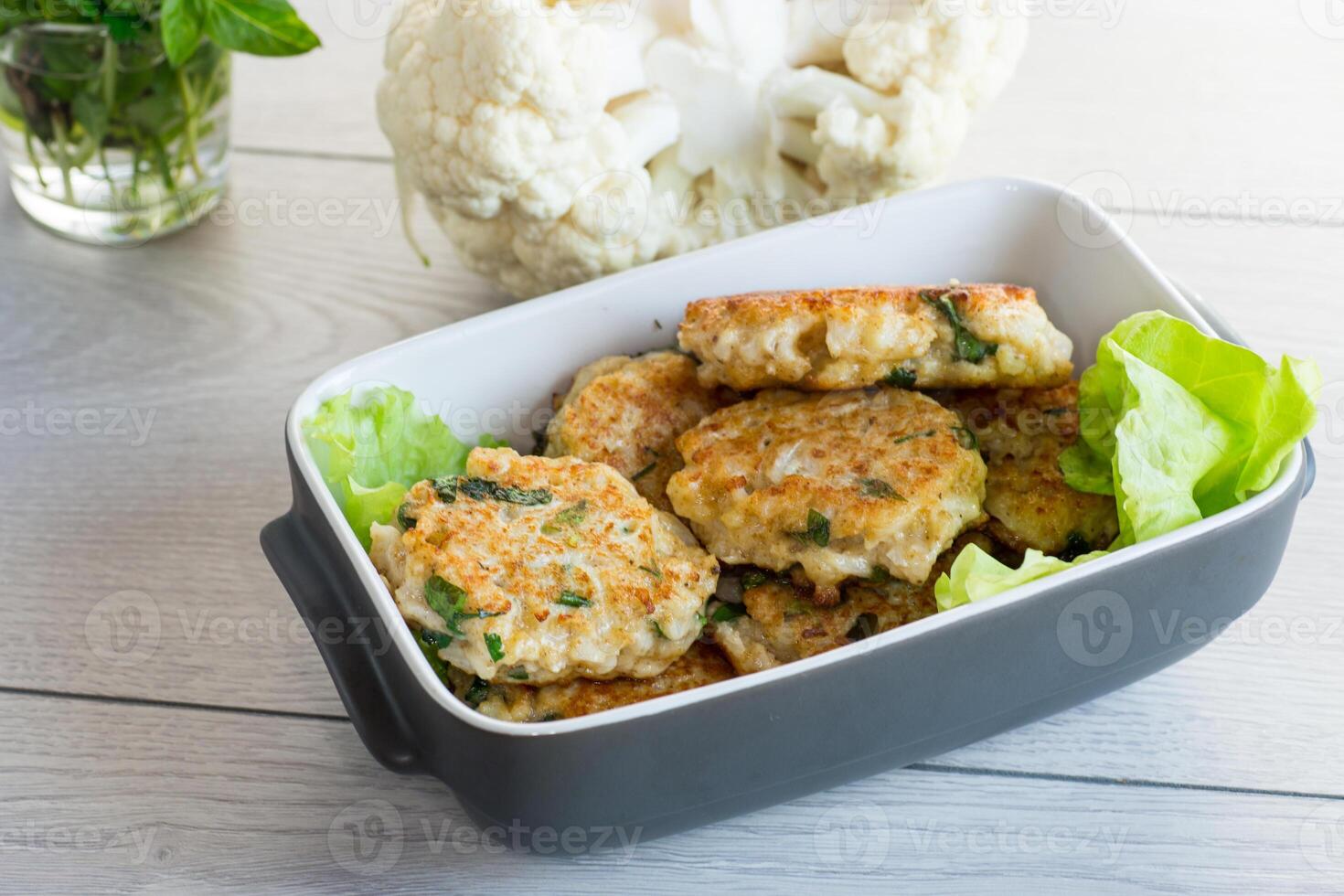 cooked vegetarian fried cauliflower cutlets in a ceramic form . photo