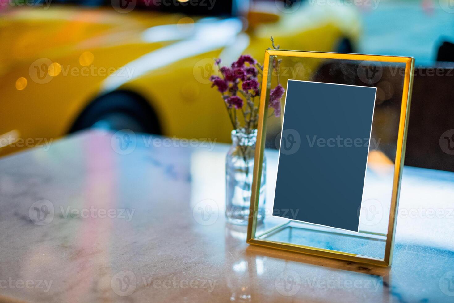 Glass frame label signboard with flower on desk photo