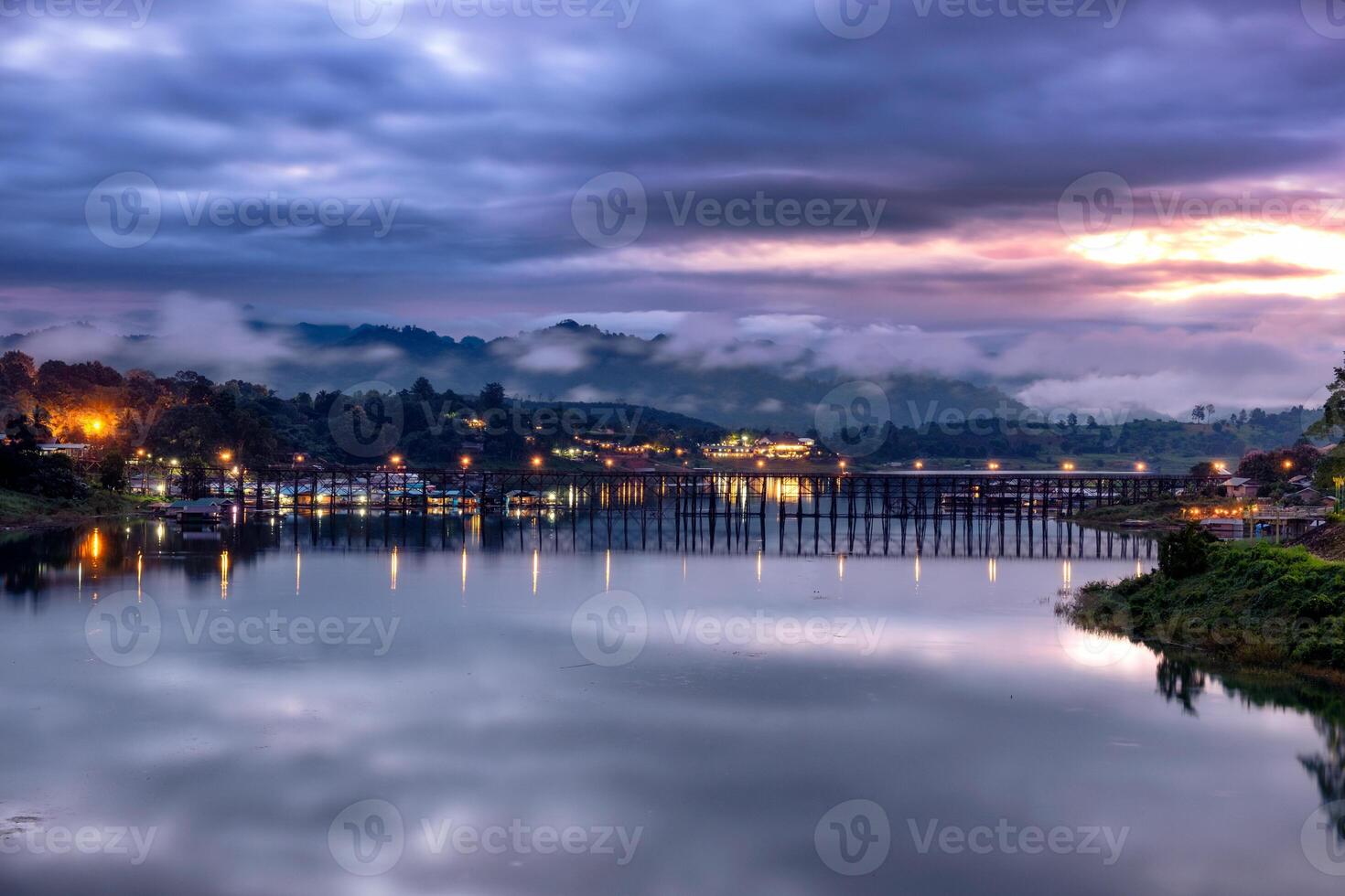 Scenics of ancient wooden mon bridge at dawn photo