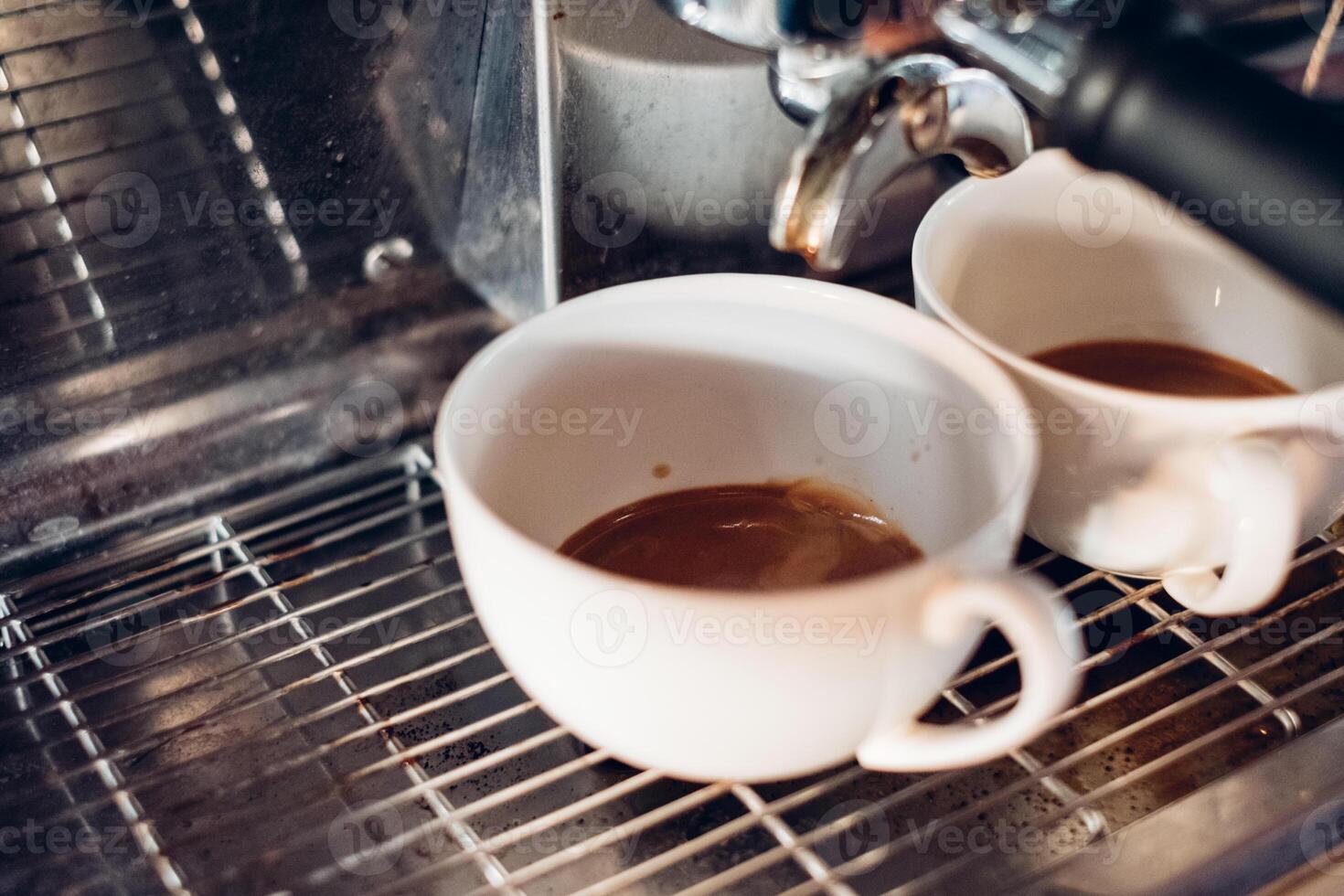 Coffee Maker making coffee in two cup photo