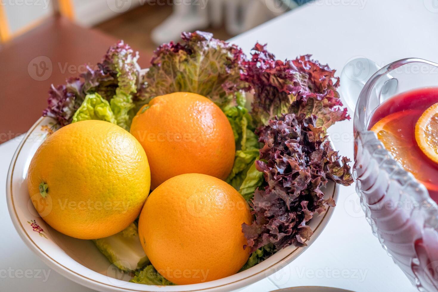Mandarin oranges with lettuce in bowl on the table photo