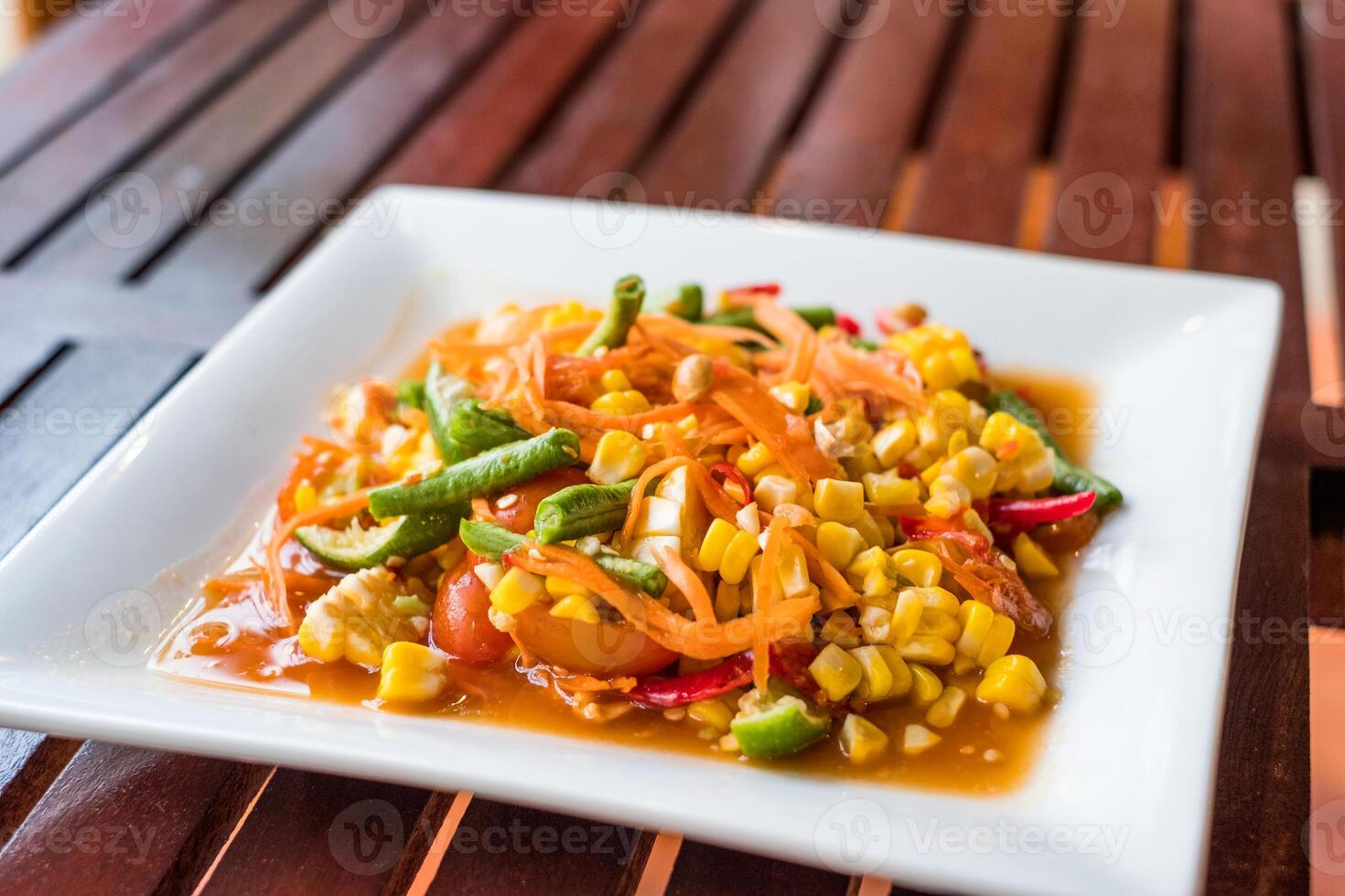 Corn seeds with fruits and vegetables sour spicy in plate photo