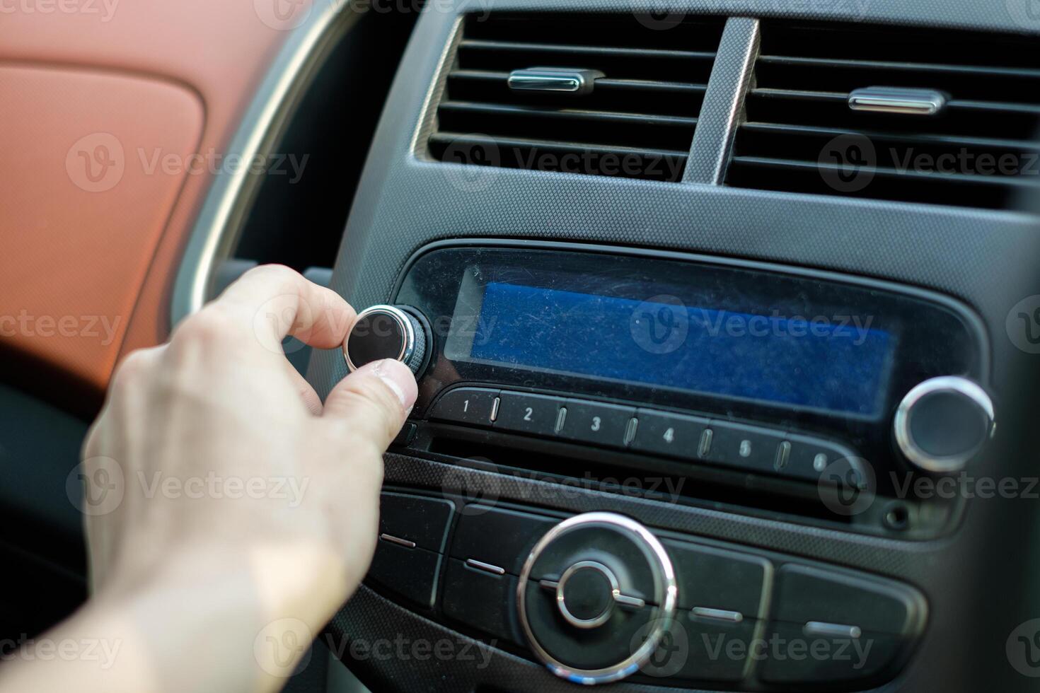 Man hand adjusting dial button car audio photo