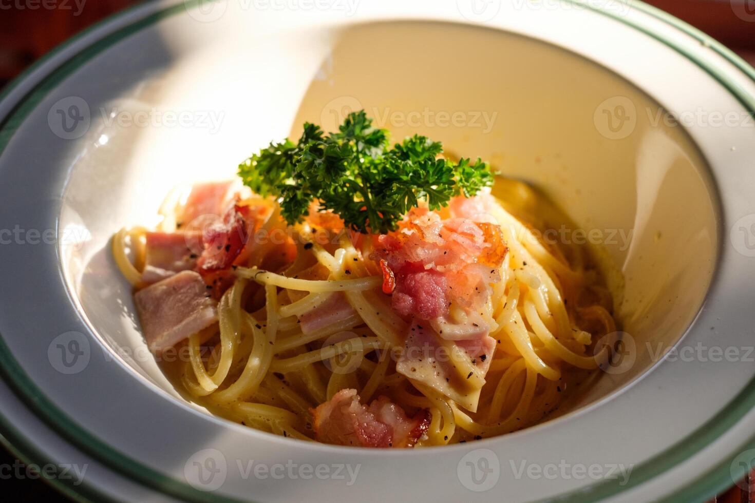 Spaghetti Carbonara with bacon, ham and vegetable in bowl photo