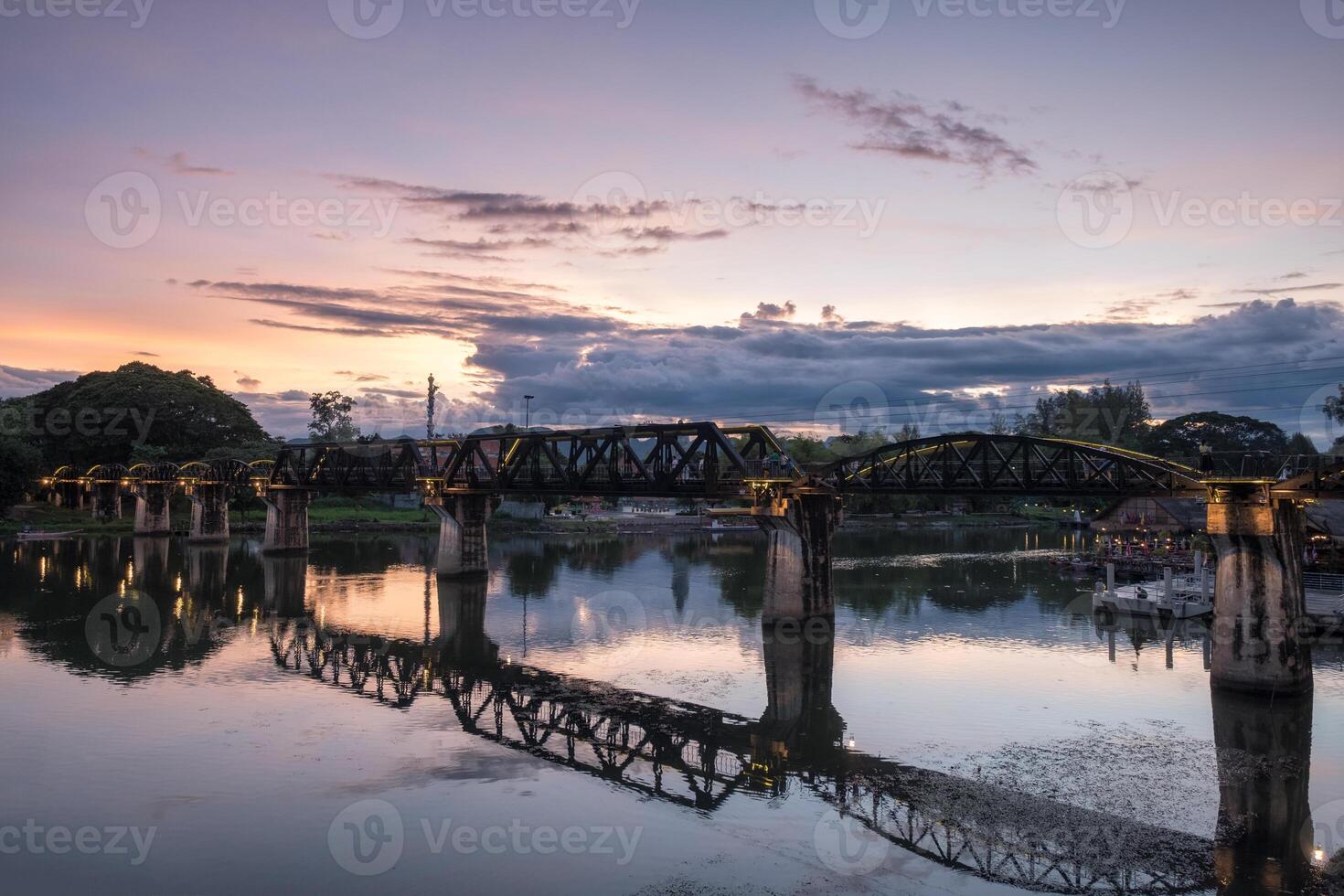 Ancient bridge on River Kwai history of world war II in evening photo