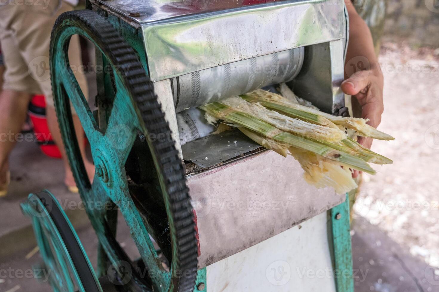 Crush machine working with crushed sugar cane in store photo