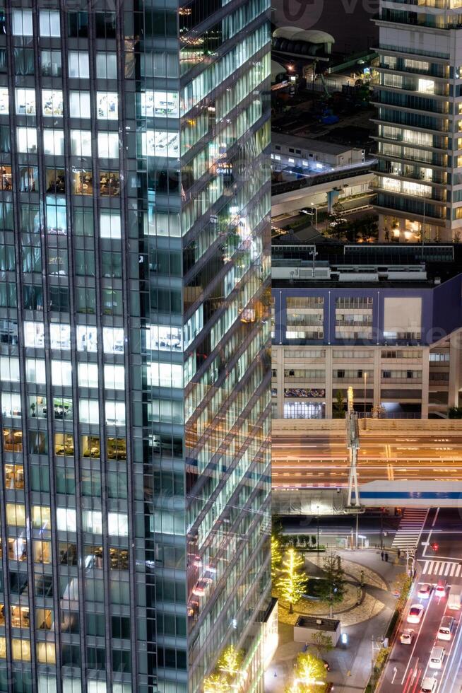 Modern building skyscraper glass window with illuminated and traffic photo