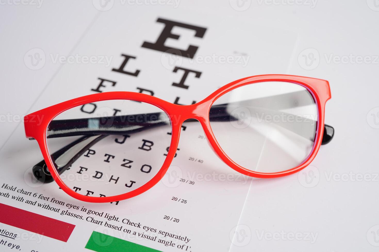 Glasses on eye exam chart to test eyesight accuracy of reading. photo