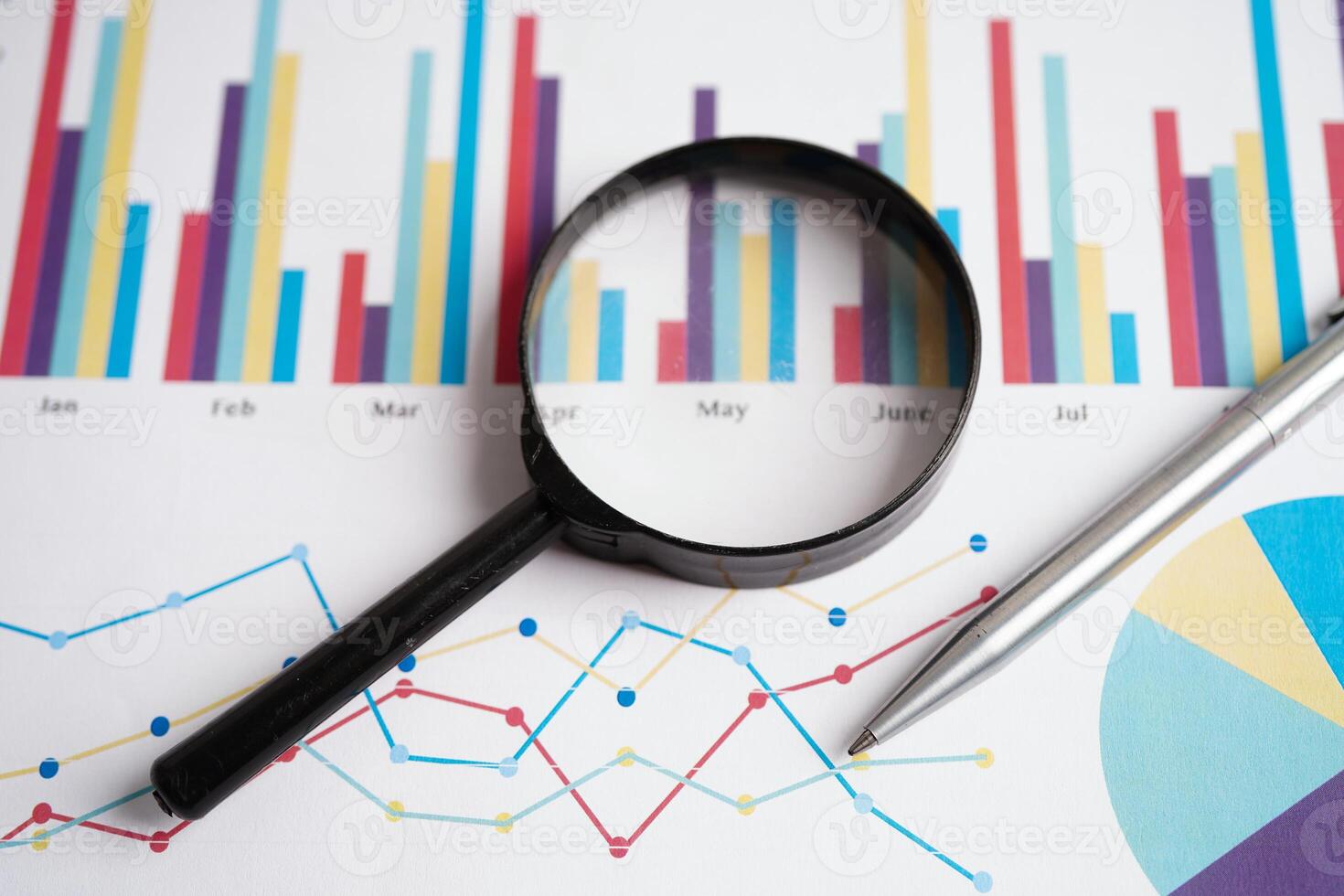 Magnifying glass on charts graphs paper. Financial development, Banking Account, Statistics, Investment Analytic research data economy. photo