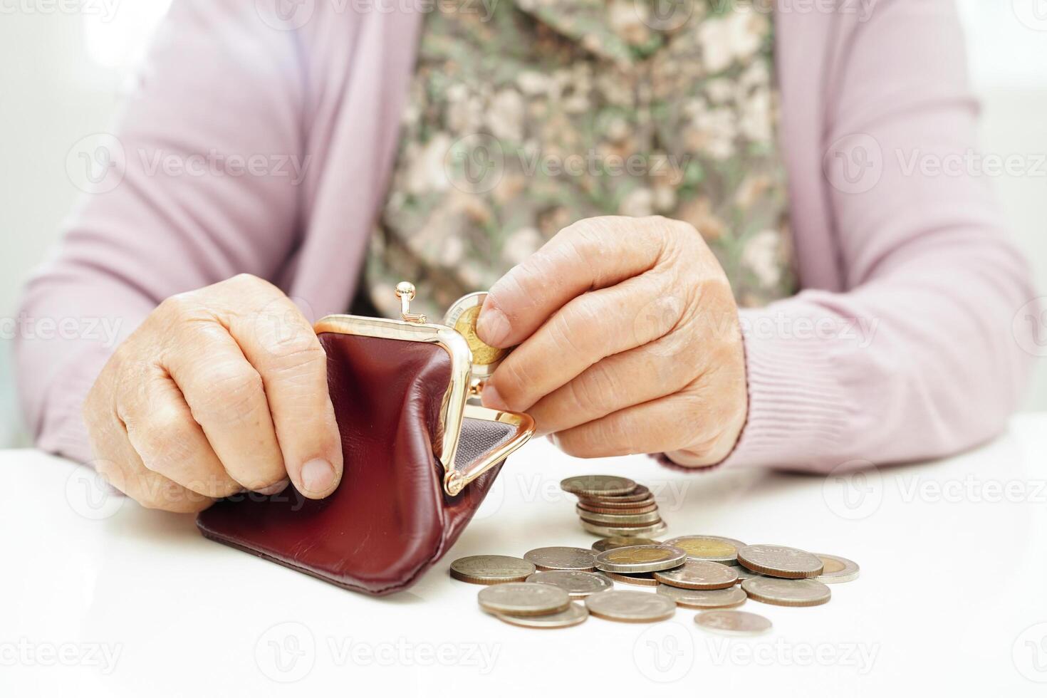 Retired elderly woman counting coins money and worry about monthly expenses and treatment fee payment. photo