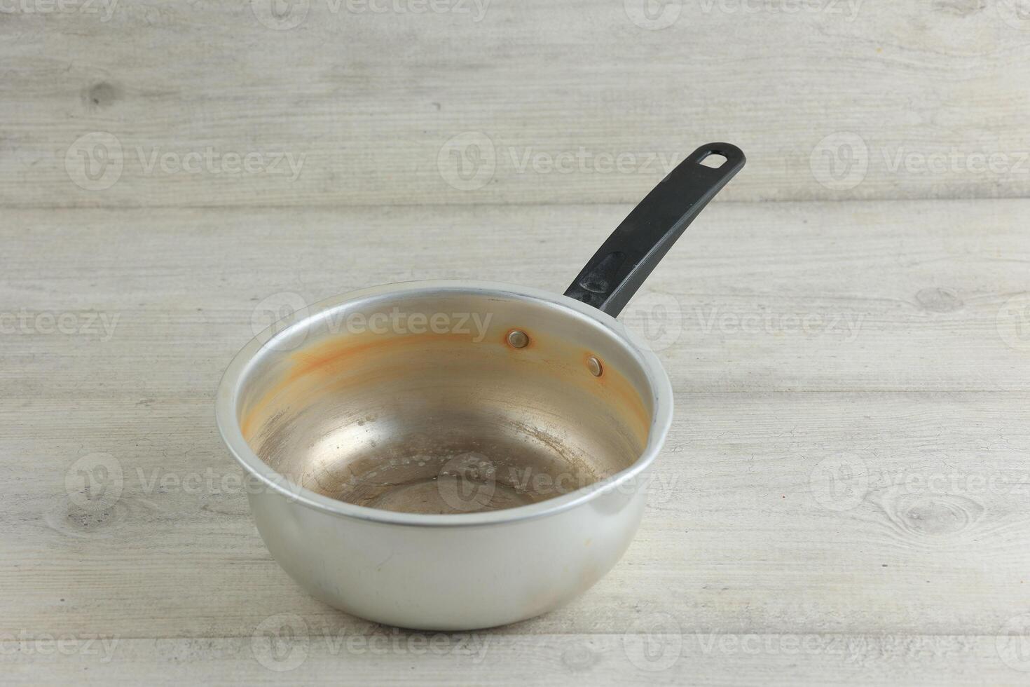 Old Used Stock Noodle Sauce Pan on White Wooden Table photo