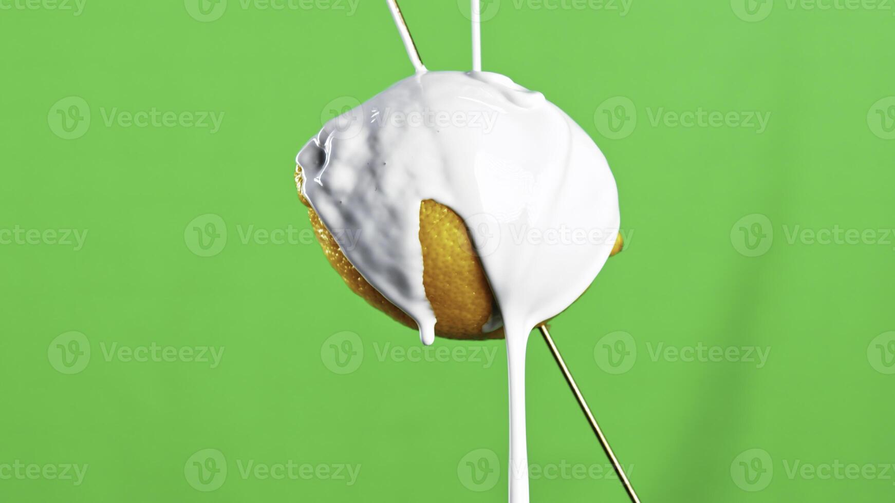 Close-up of products in cream. Stock clip. Food filled with white liquid. Food is spoiled by white paint on isolated background photo