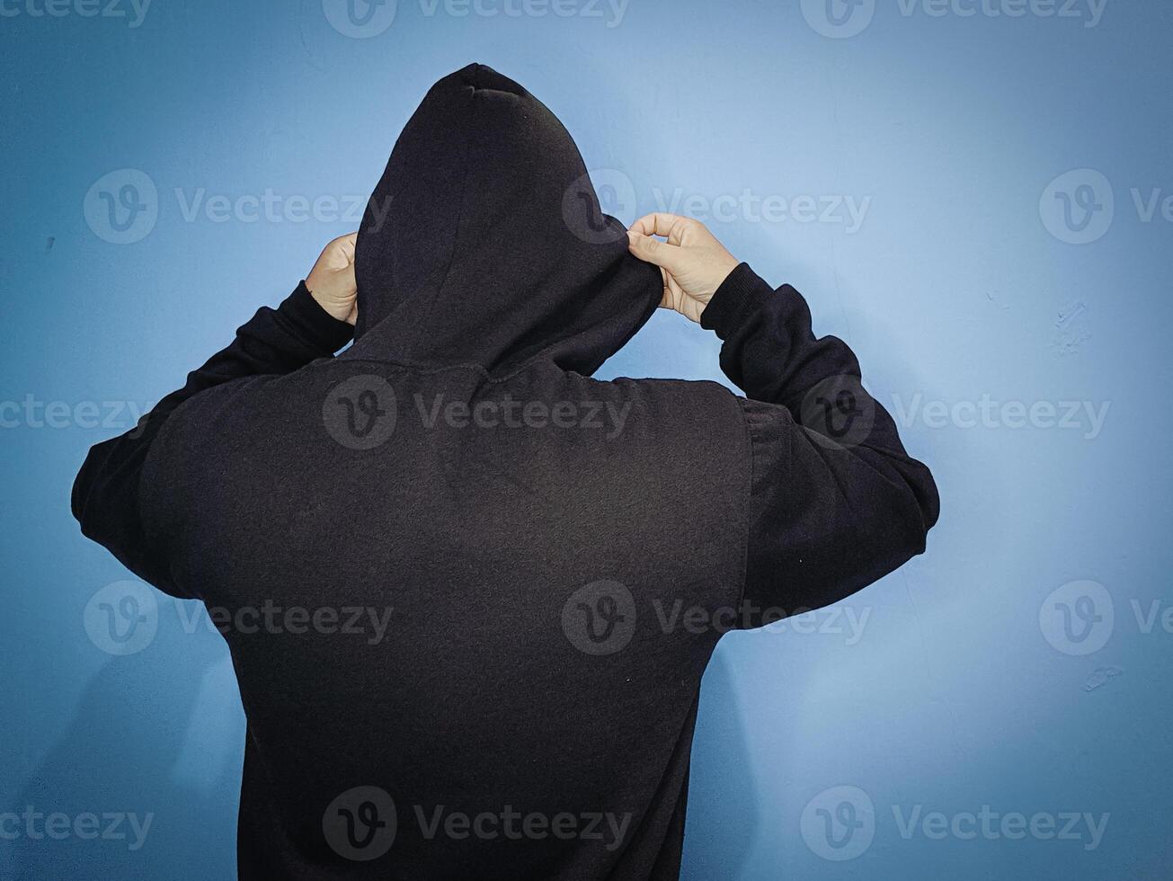 A man in a black jacket poses with his hood off photo