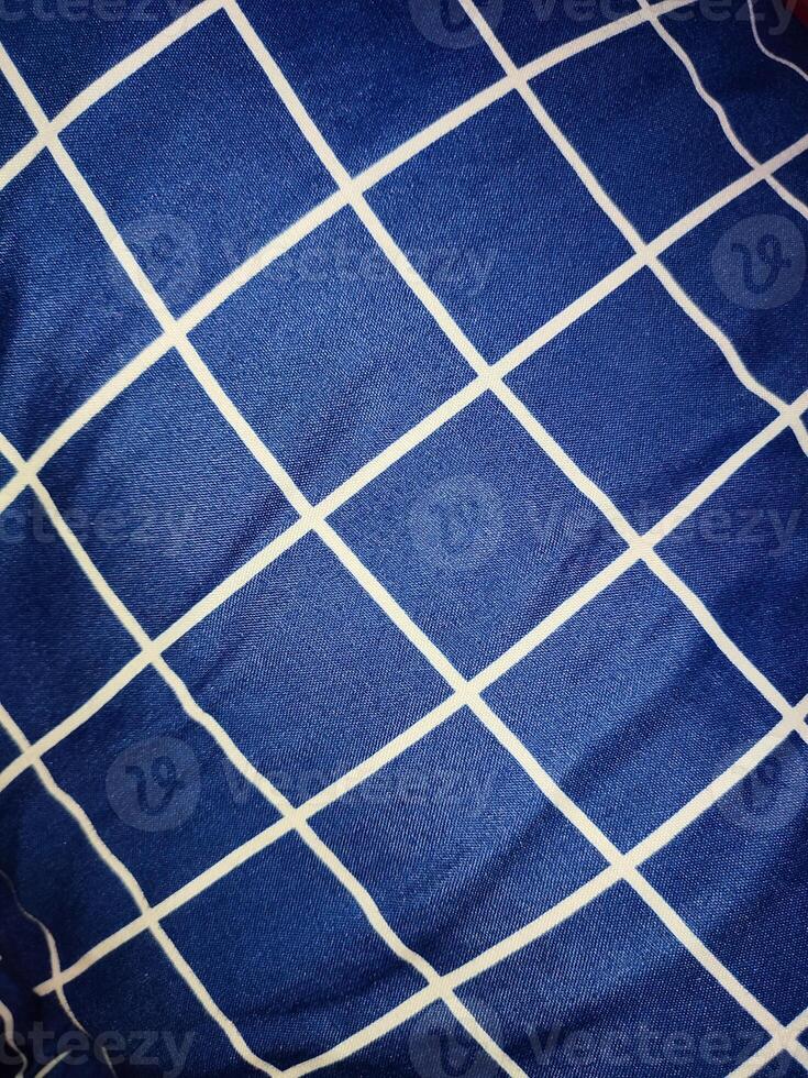 Close-up of blue and white checkered napkin or picnic tablecloth texture, kitchen accessories. photo