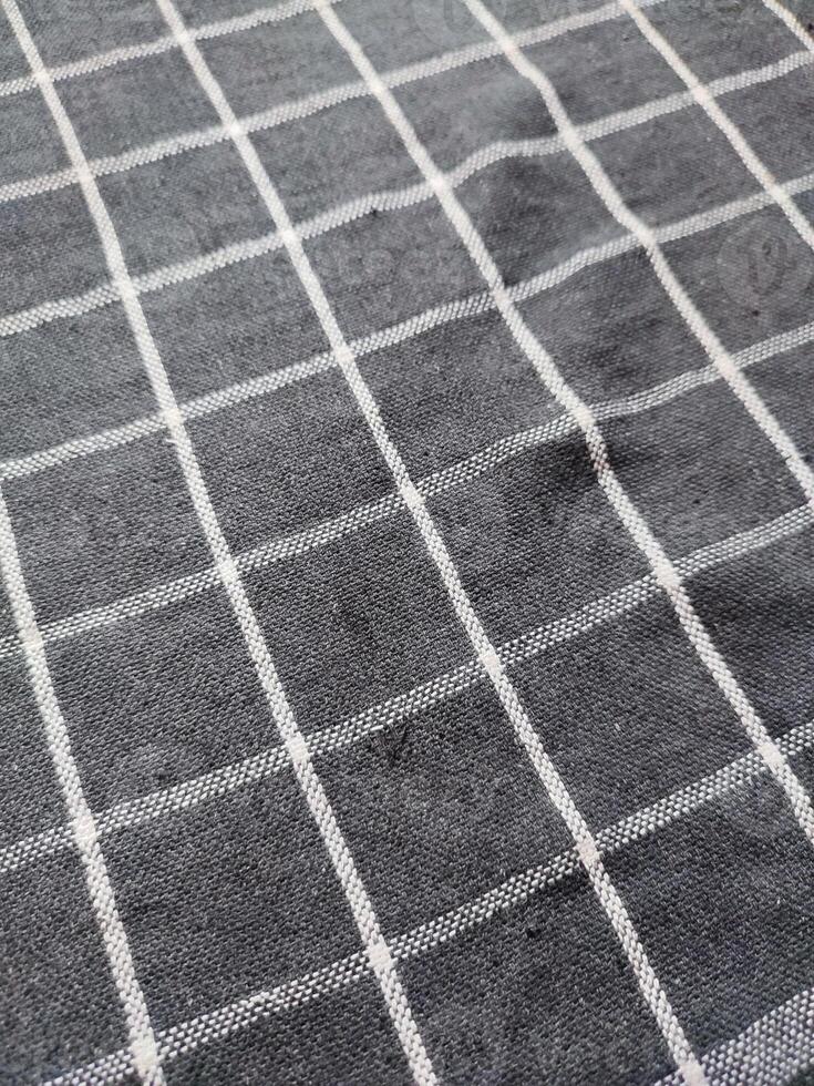 Close-up of black white checkered napkin or picnic tablecloth texture, kitchen accessories. photo
