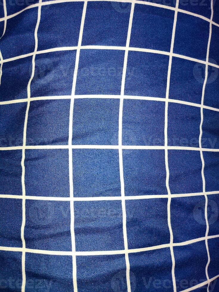 Close-up of blue and white checkered napkin or picnic tablecloth texture, kitchen accessories. photo