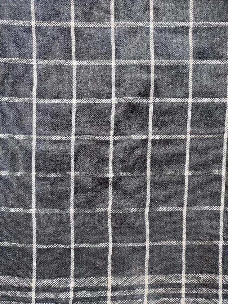 Close-up of black white checkered napkin or picnic tablecloth texture, kitchen accessories. photo