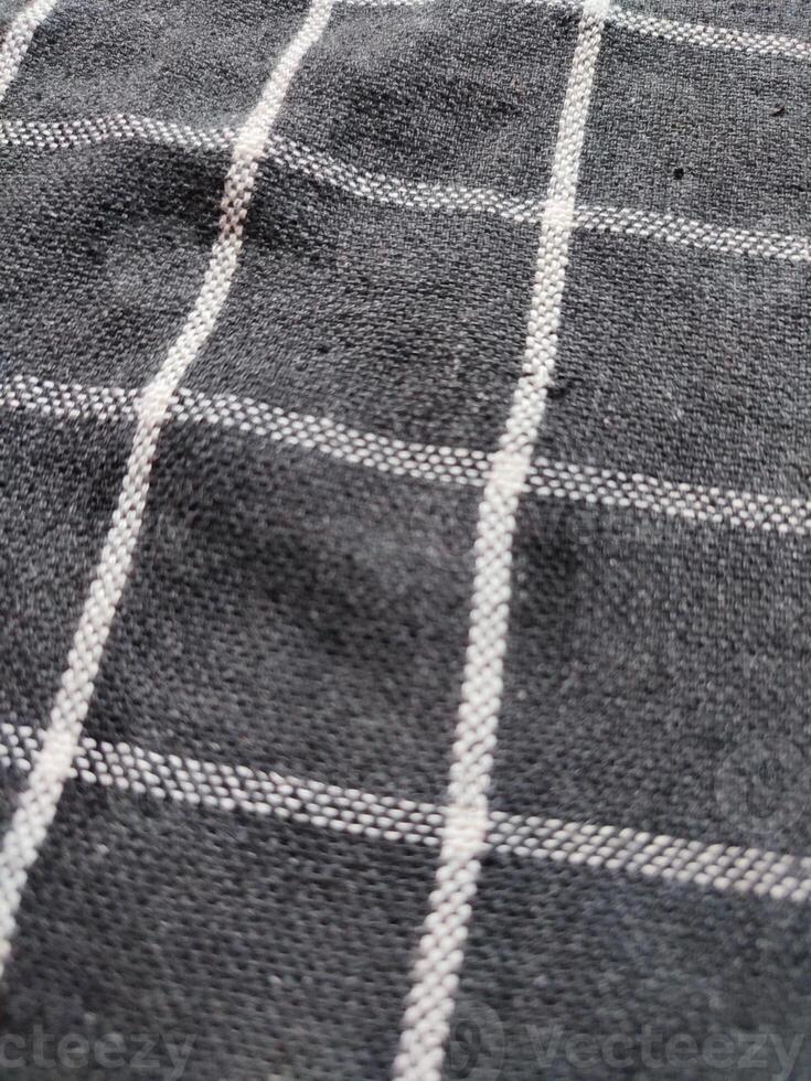 Close-up of black white checkered napkin or picnic tablecloth texture, kitchen accessories. photo