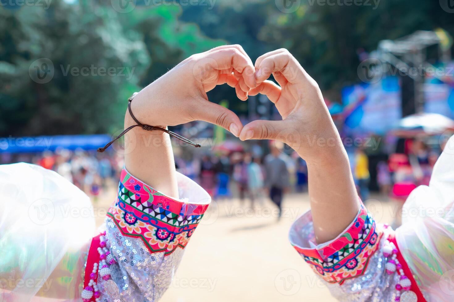 woman raised her hands and made heart symbol to express meaning of love friendship and kindness to her friends and lovers. woman uses her hands to make a heart symbol that means love and friendship. photo
